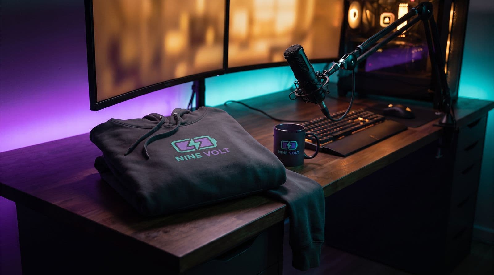 A branded NINE VOLT hoodie and mug sit on a dimly lit streaming desk illuminated by purple and teal LED lighting.